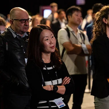 People listening to a speaker on stage