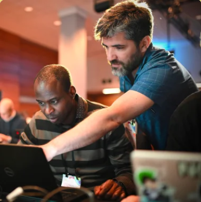 two man looking at a laptop
