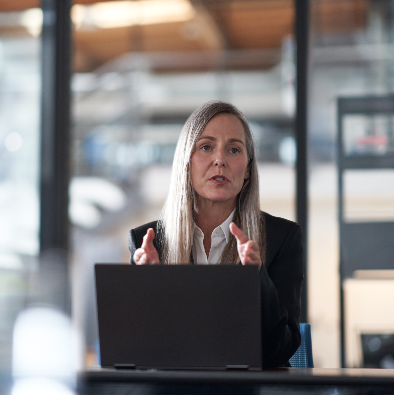 woman speaking in front of a laptop